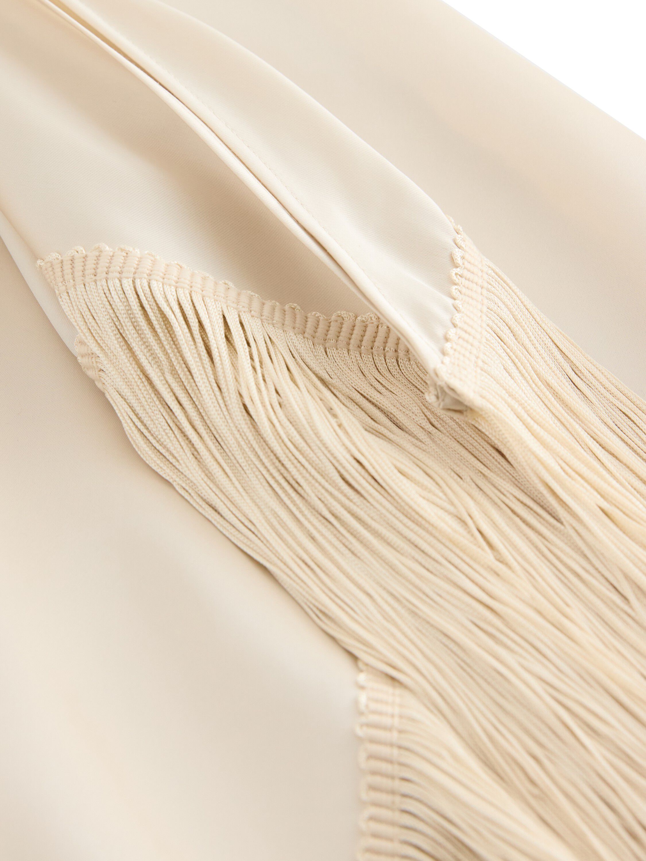 Satin skirt with fringe details.