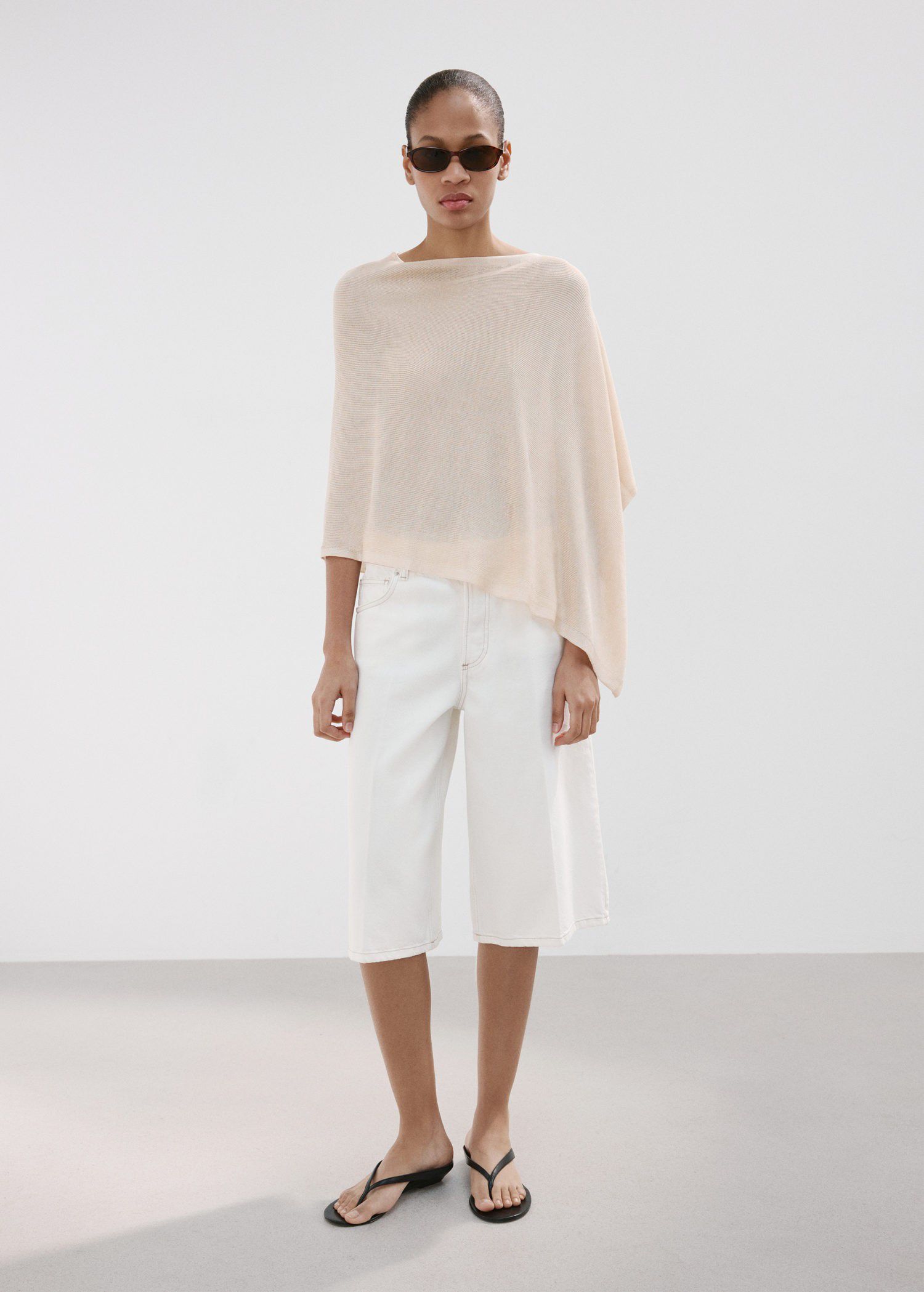 Asymmetrical knitted cape