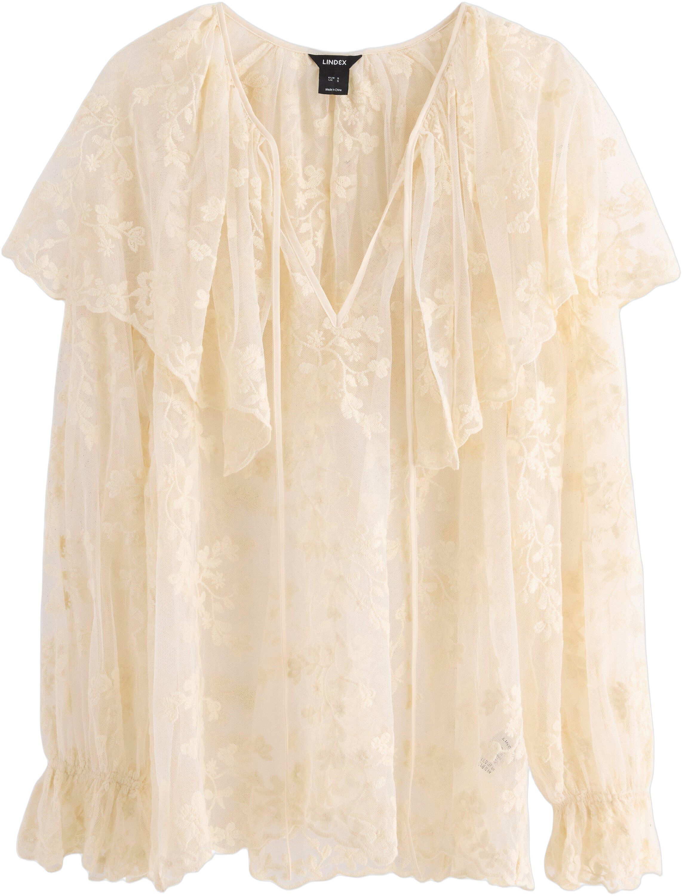 Sleeveless blouse in lace and mesh.