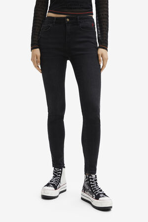 Sustainable black mid-rise skinny jeans with contrasting heart embroid